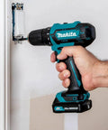 12V Max Cordless Drill Driver Kit With 3/8 In Chuck Two 2Ah Batteries Renewed Variable Speed 0 to 450 and 0 to 1700 RPM being used on wall