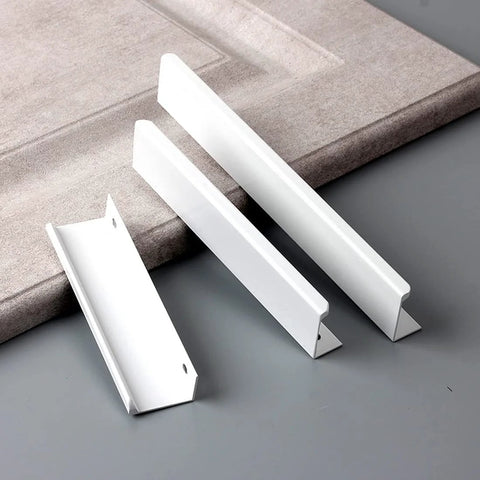 Six Pack Finger Edge Drawer Pull Handles In Bright White, three aluminum handles on grey surface, highlighted hidden mount design.