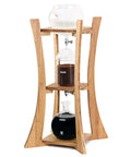 Kick Back And Sip Smooth Cold Brew With This Sleek Dutch Coffee Maker And Glass Tower Designed For Fifteen Friends Featuring Bamboo Frame and No Fuss Drip System For Fresh Iced Sips Anytime.