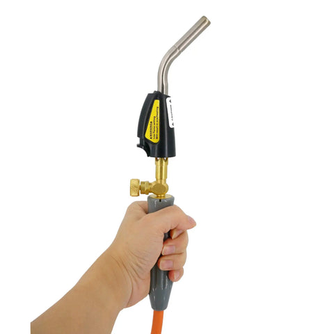 Hand holding propane powered welding torch with stainless steel head, part of kit with 20 lb tank, 60 inch hose, for DIY metal work.