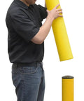 Hecka Sturdy Low Density Polyethylene Bollard Post Cover Slides On With Zero Sweat Shields Concrete Posts Indoors Or Out 52 By 5 Inches Bright Yellow Warehouse Floor Delineator being installed by a worker wearing a yellow hard hat.