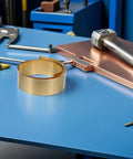 Brass Sheet Roll for Jewelry Making and Crafting with Copper Foil Tape for Grounding and Heat Transfer, Dope for Automotive Parts, Mechanical Projects, and Craft Foil Applications, Easy Cut and Form with High Thermal Conductivity. brass roll on workshop bench