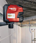 Green Beam Line Laser PM 2 LG with horizontal and vertical alignment mounted on wall for precise DIY and pro projects