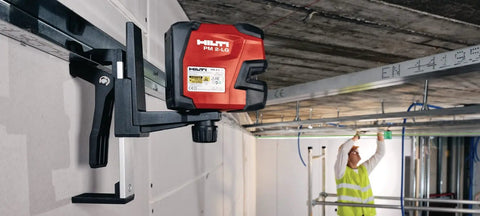 Green Beam Line Laser PM 2 LG with horizontal and vertical alignment mounted on wall for precise DIY and pro projects