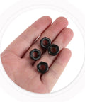 Heavy Duty M8 Locking Nuts For Skateboard Trucks 50 Piece Bombproof Iron Hardware Kit held in a hand, showcasing black zinc finish.