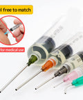 Close-up of Pro Grade Glue Applicator Syringe Set with blunt tip needles and colorful caps for non-medical use, shown at angle.