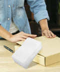 Stack of EPE Foam Pouches for Packing Dishes and Protecting Electronics shown next to a person packing a box