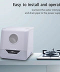 Real Deal Portable Countertop Dishwasher With Foolproof Leak Seal For Dorms Apartments RV Offices on a kitchen counter next to a stovetop.