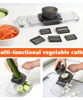 Front-view kitchen mandoline slicer with 6 blades and safety hand guard; stainless steel blades, clear plastic base