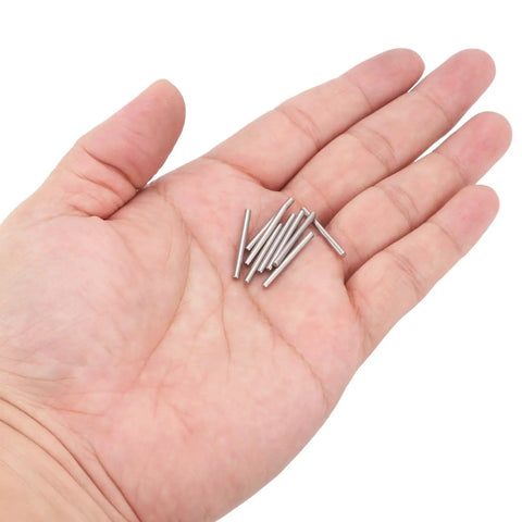 Hand holding a few pieces from 50 Pieces Dowel Pins Set 2mm By 22mm 304 Stainless Steel Durable Rust Resistant Fasteners For Shelves And Projects Assortment Kit Silver Heavy Duty Quick Fit For Shelves And Cabinets In Home Workshop Durable And Versatile