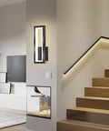 Sleek Rectangular LED Wall Sconce Delivering Flat Out Stunning Three Tone Lighting And Smooth Acrylic Glow To Elevate Any Hallway Bedroom Corner With Zero Effort Chic Vibes mounted beside stairs.