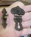 Five Piece Set Of Retro Antique Bronze Heart Shaped Box Hasp Lock Latches featuring tough zinc alloy construction in hand.