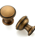 20 Pack Antique Brass Cabinet Knobs 1-1/4 Inch Round Drawer Handles with Fingerprint Resistant Swanky Finish for Kitchen Cabinets and Dressers Adding That Vintage Charm to Any Room Right Now, showcasing two round knobs.