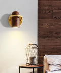 Fly Modern Metal Led Wall Sconce With Bulb Hardcore Adjustable Indoor Reading Lamp Featuring Slick Imitation Wood Grain Finish For Bedroom Kitchen Corridor mounted on wall above a round side table.