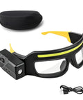 Badass Rechargeable LED Safety Glasses With Dual LED Spot And Flood Lights Five Bright Lighting Modes For Camping Hiking And Night Shift Work Gear That Is A Total Game Changer For Anyone On The Go, shown with USB charging cable and carrying case.