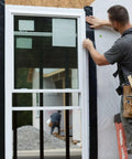 Person installing Pro Grade Flashing Tape For Windows And Doors, 3.75 Inch Wide, 30 Foot Roll, all weather and UV resistant.