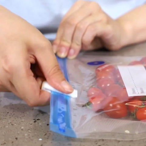 Using 30 Pack Vacuum Storage Bag Sealing Clips Quick Snap Zipper Grips on bag with tomatoes for preservation