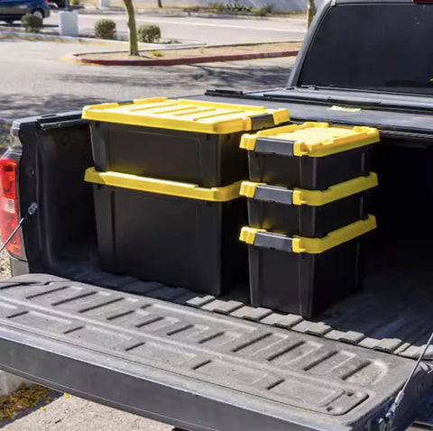12 Gallon Heavy Duty Storage Tote Set of 3 Black Plastic Bins Featuring Secure Yellow Lids arranged in a truck bed.