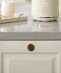 Set Of 10 Antique Brass Cabinet Knobs And Zinc Alloy Drawer Pulls For Kitchen Cabinets And Furniture, shown on white cabinet