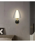 Straight Up Modern Led Wall Sconce With Soft Glowing Acrylic Shade lights up bedroom with elegant design.