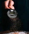 Flour Duster For Baking One Handed Operation Stainless Steel Powdered Sugar Shaker Duster in use dusting cocoa powder