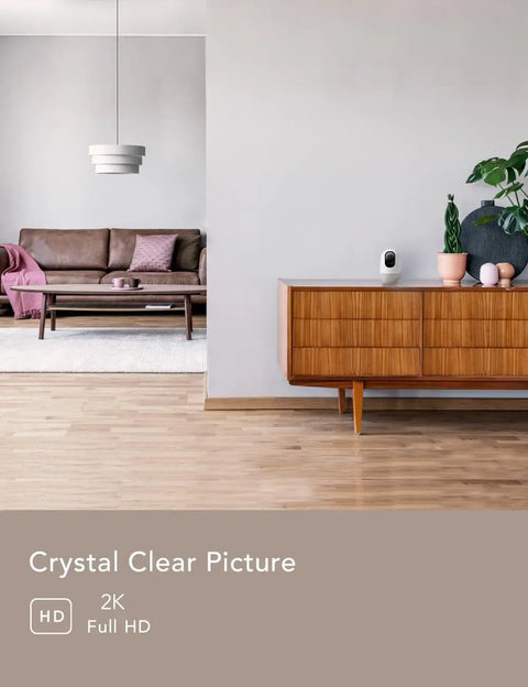 2K Indoor WiFi Baby And Pet Camera With 360 Degree Pan And Tilt AI Motion Tracking on modern cabinet in living room
