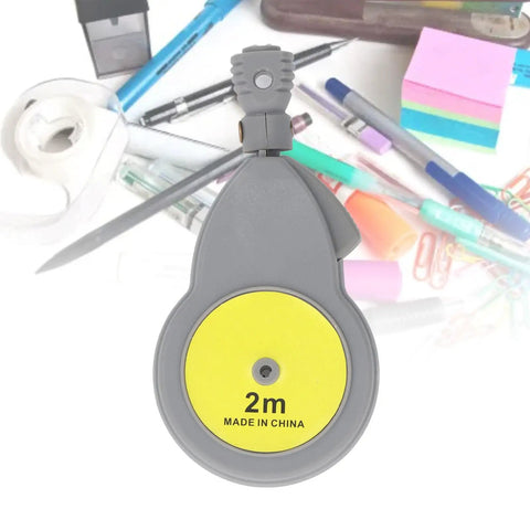 Heavy Duty Rotating Beam Compass With Retractable Tape Measure And Fifty Pencil Refills For No Sweat Pro Shop Layouts And Dead Nuts Dual Scale Accuracy showing yellow tape measure with a grey casing.