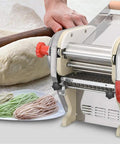 Top Shelf Stainless Steel Pasta Roller And Cutter Attachment Set Smooth Rolling Dough Presser For Home Kitchens, dough and noodles in view.