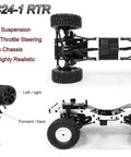 Rugged One Sixteenth Scale RC Rock Crawler Truck 4x4 chassis with remote, showcasing suspension and steering components.