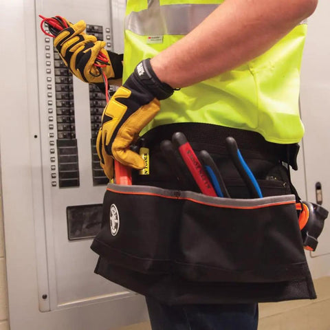 Electrician using Heavy Duty Tool Apron With Reinforced Bottoms And Four Pockets For Hand Tools Tape Thong And Pencil Pockets Adjustable Belt
