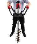 Man operating a Powerful Electric Post Hole Digger Auger Kit 1500W 110V 1.6HP with 4 Inch Bits and 12 Inch Extension digging soil.