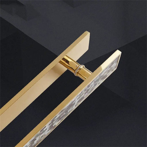 Close-up of European Stainless Steel Gold Shell Door Handle For Hotels And KTV Push And Pull Armrest in gold finish