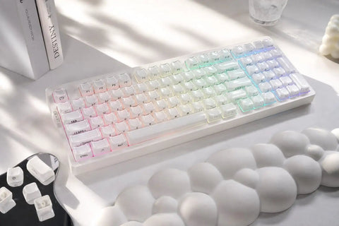 Wireless Mechanical Gaming Keyboard With 95 Percent Layout And Integrated Number Pad In Cream White Glossy Cat Ear Keycaps Running Smooth Creamy Switches With Vibrant Rgb Lighting For Your Sick Desk Setup on a white surface.