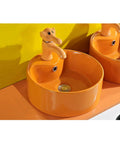 USZWBY Bathroom Vessel Sink Cute Round Ceramic Bathroom Sink with Animal-Shaped Faucet Sink Set Bathroom Sink in bright orange.