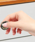 Hand reaching for a Pretty Dang Slick Antique Zinc Alloy Cabinet Drawer Pulls And Round Vanity Knobs for kitchen cabinet.