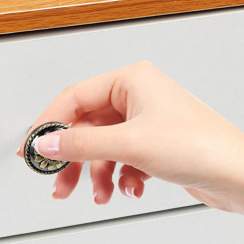 Hand reaching for a Pretty Dang Slick Antique Zinc Alloy Cabinet Drawer Pulls And Round Vanity Knobs for kitchen cabinet.