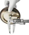 Measuring 5-Inch CBN Bandsaw Grinding Wheel thickness with caliper, designed for 7/8 inch tooth spacing, 10/30° pitch, silver color.