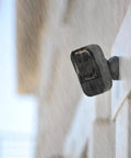 Wireless Outdoor Security Camera 1080P HD Night Vision Motion Detection Weatherproof mounted outside a building in rain