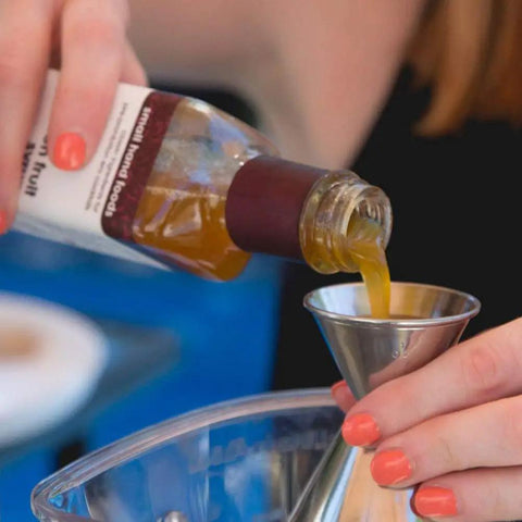 Pouring ingredient into Double Jigger Cocktail Set 1oz/2oz Stainless Steel Barware for home bar use with markings visible
