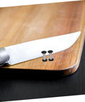 Badass Flat Head Knife Handle Screws And Brass Snap Rivets For Wood And Metal Crafts Tight Fit 2 Piece Kit on a wooden cutting board.