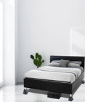 Heavy Duty Bed Riser Set 3 Inch Elevates Beds Couches Desks Sofas And Bunk Posts 4 Pack For Extra Storage And Space Saving In Small Rooms Dorms And Apartments shown under a bed in a modern bedroom.