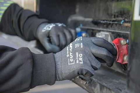 Person wearing Cut-Less Korplex Glove With Foam Nitrile Palm For Cut Resistance And Dexterity adjusting machinery