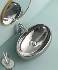 USZWBY Bathroom Vessel Sink European Ceramic Sink Art Basin Chrome Wash Basin Oval Sink Bathroom Sink Washbasin Above Counter Basin with Faucet,Silver Bathro viewed from above with faucet and mirror.