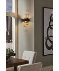 Adagio Collection 2 Light Black Modern Wall Light With Geometric Interlocking Elements in a stylish living room setting