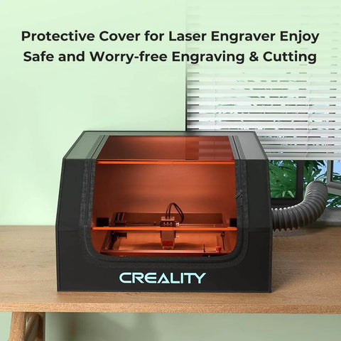 Creality laser engraver enclosure; black plastic housing with orange interior, front view, fireproof and dustproof.