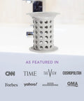 Big Time Win For Your Bathroom Two Inch Stand Up Shower Drain Protector Hair Catcher Strainer Gray Clog Guardian on a tub edge.