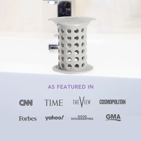 Big Time Win For Your Bathroom Two Inch Stand Up Shower Drain Protector Hair Catcher Strainer Gray Clog Guardian on a tub edge.