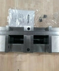 Six Inch Double Lock Cnc Machine Vise With Hardened Steel Bed And Reversible Step Jaws For Heavy Duty Fabrication shown from above with measuring tool.