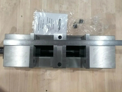 Six Inch Double Lock Cnc Machine Vise With Hardened Steel Bed And Reversible Step Jaws For Heavy Duty Fabrication shown from above with measuring tool.