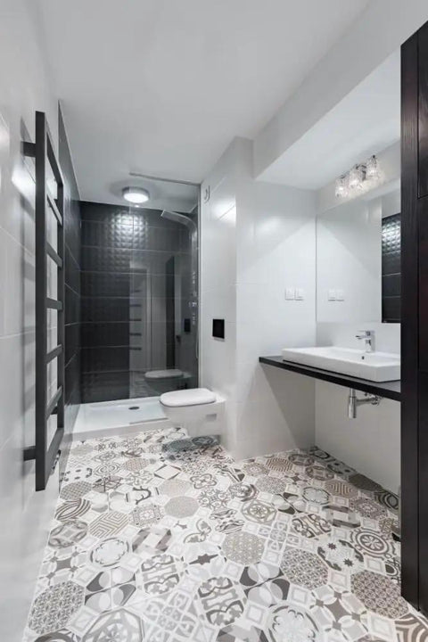 Modern bathroom interior with patterned floor tiles, white fixtures, and Three Light Vanity Fixture With Crystal Glass Shades Transitional Contemporary Bathroom Light Model 1931-3V-CH.